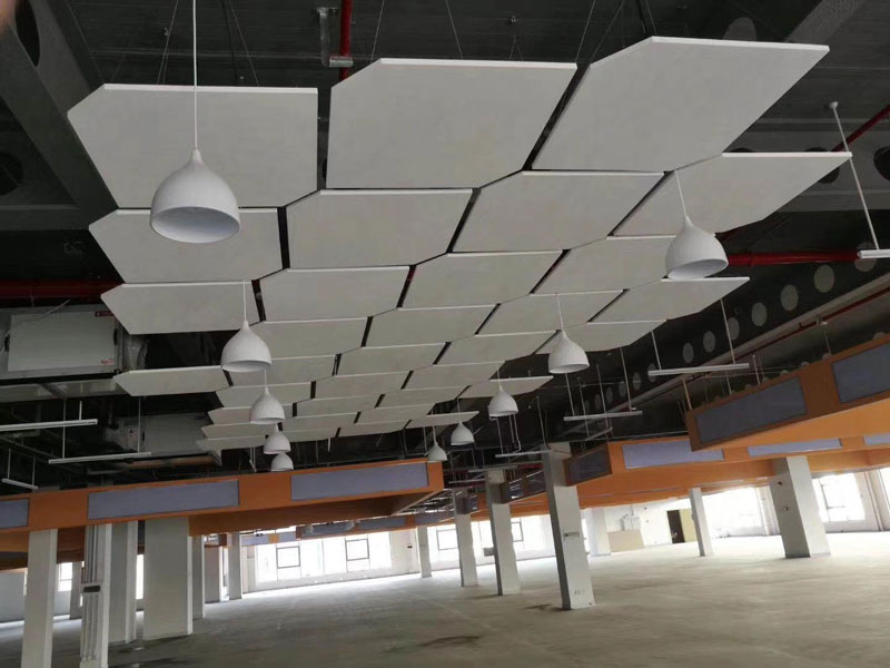 Dark auditorium ceiling fitted with acoustic PET baffles for enhanced sound quality in a Saudi cinema
