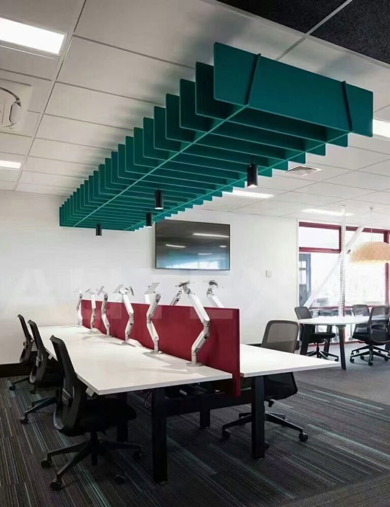 Modern open-plan office in Riyadh featuring suspended acoustic PET felt baffles on the ceiling to control noise